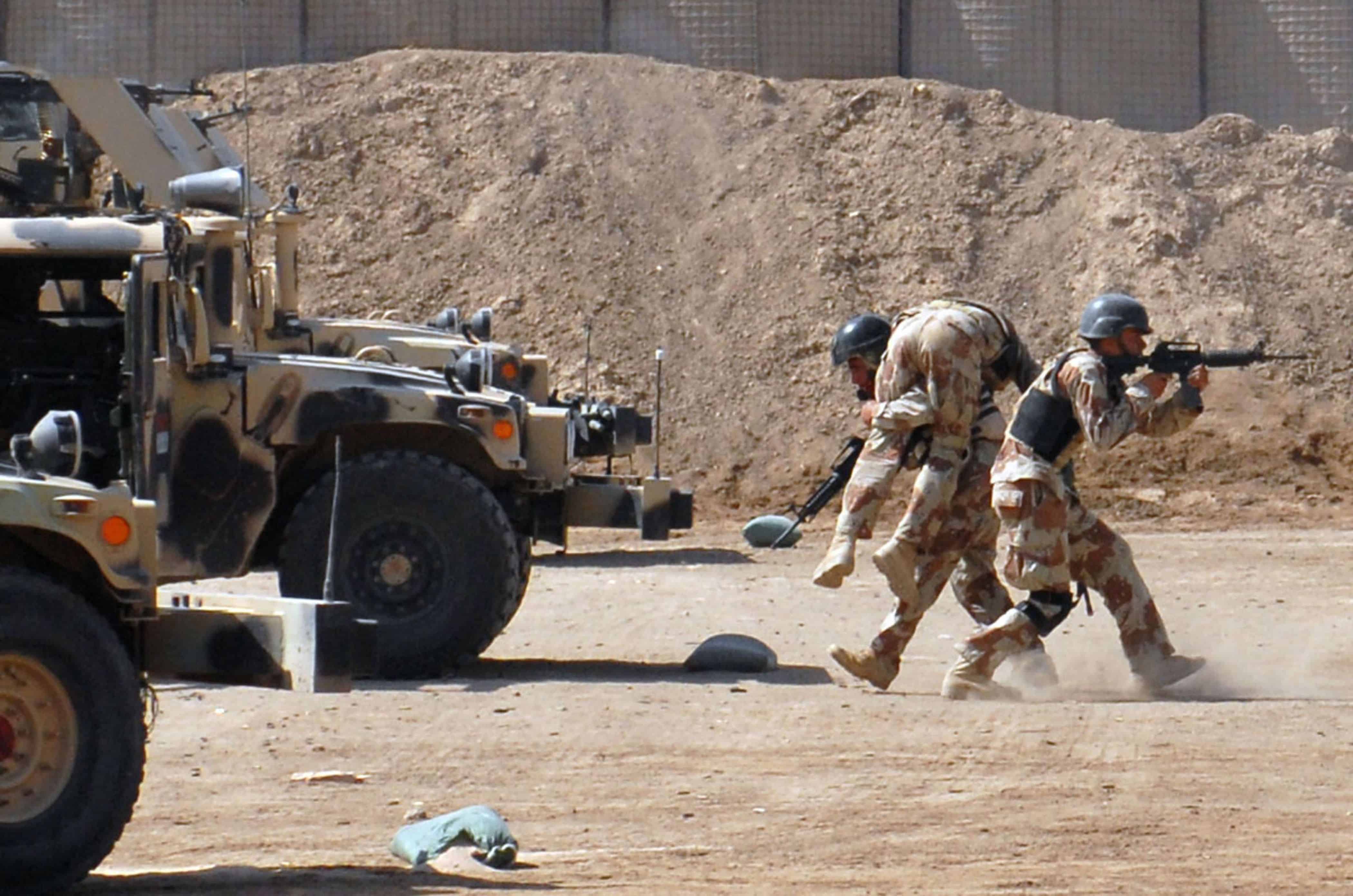 An Iraqi special operations forces soldier carries his fellow soldier during a simulated "down-soldier" drill during an ISOF convoy security course graduation, March 7. During the demonstration, they displayed their expertise by firing from their knee, standing and even from a moving vehicle.