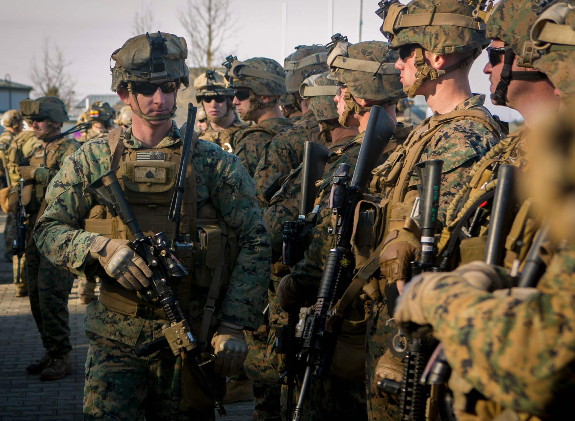 U.S. Marine Sgt. Garrett Jackson, a squad leader with Special-Purpose Marine Air-Ground Task Force Crisis Response-Africa, checks his team before setting out on a mock assault with U.S. Army Special Forces in Baumholder, Germany, March 11, 2015. Jackson led his squad through more than a week of training with Special Forces personnel to prepare the two groups to conduct future operations together. (U.S. Marine Corps photo by Sgt. Paul Peterson/Released)