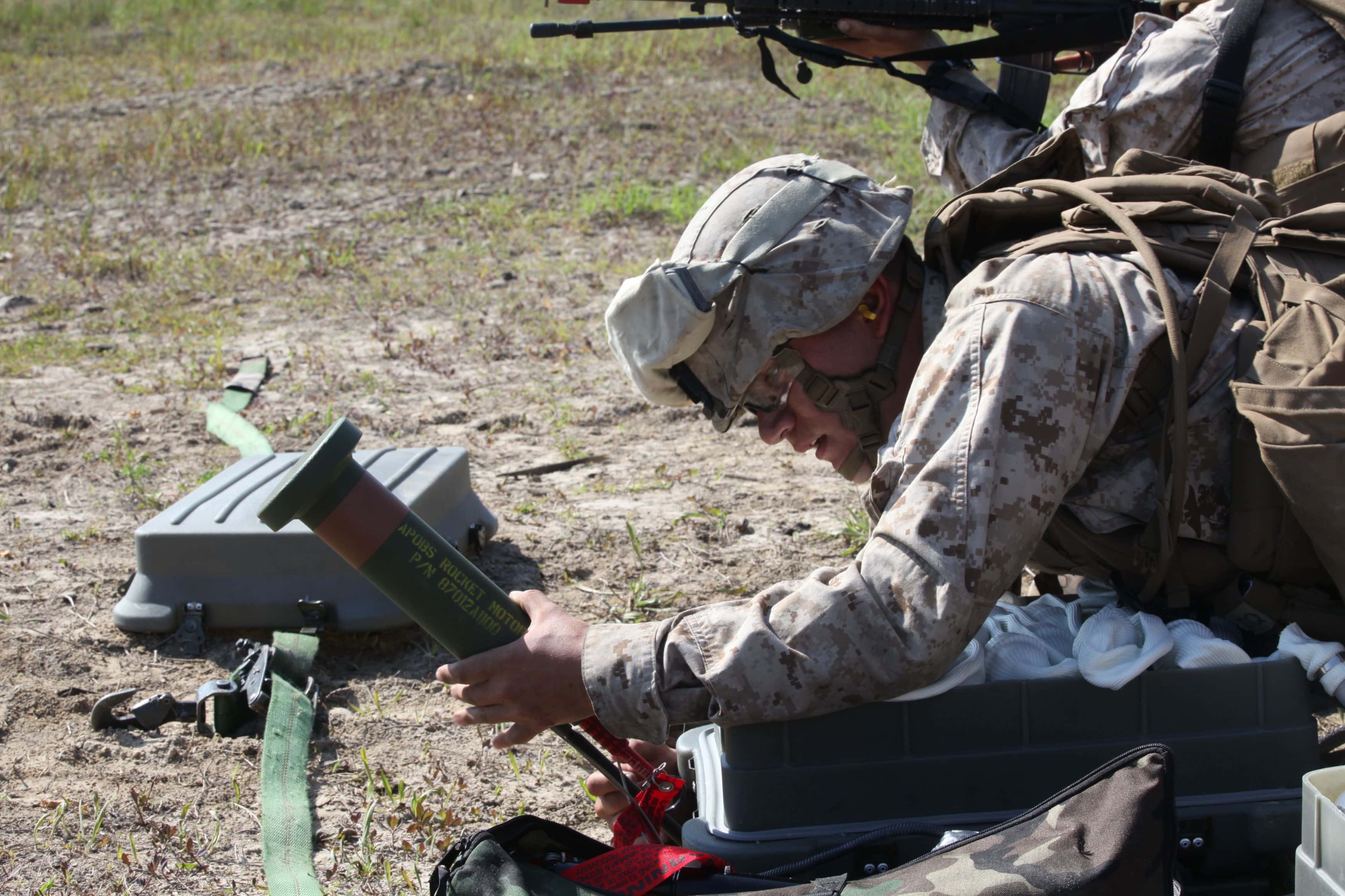 Pfc. Steven A. Olivas, a combat engineer with 2nd Combat Engineer Battalion, 2nd Marine Division, prepares the rocket used to deploy an Anti-Personnel Obstacle Breaching System. After the pin is pulled, there is a time delay in order to provide the Marines time to fall back under cover to ensure no casualties from the grenades exploding. (U.S. Marine Corps photo by Pfc. David N. Hersey/Released)