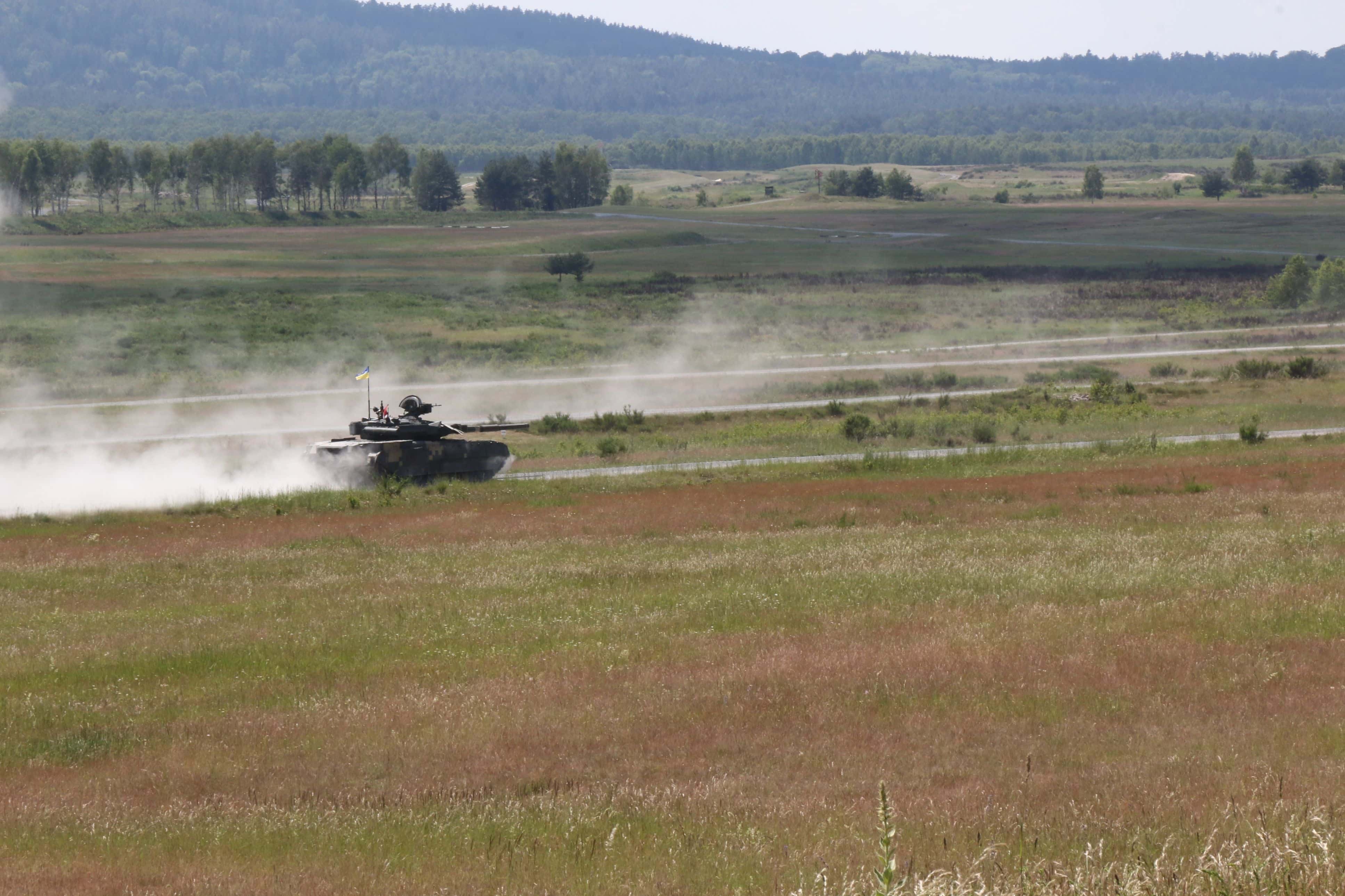A Ukrainian T-84 tank moves down range on the Grafenwoehr Training Area's Range 117 to conduct the offensive operations lane during the 2018 Strong Europe Tank Challenge, June 4, 2018.
