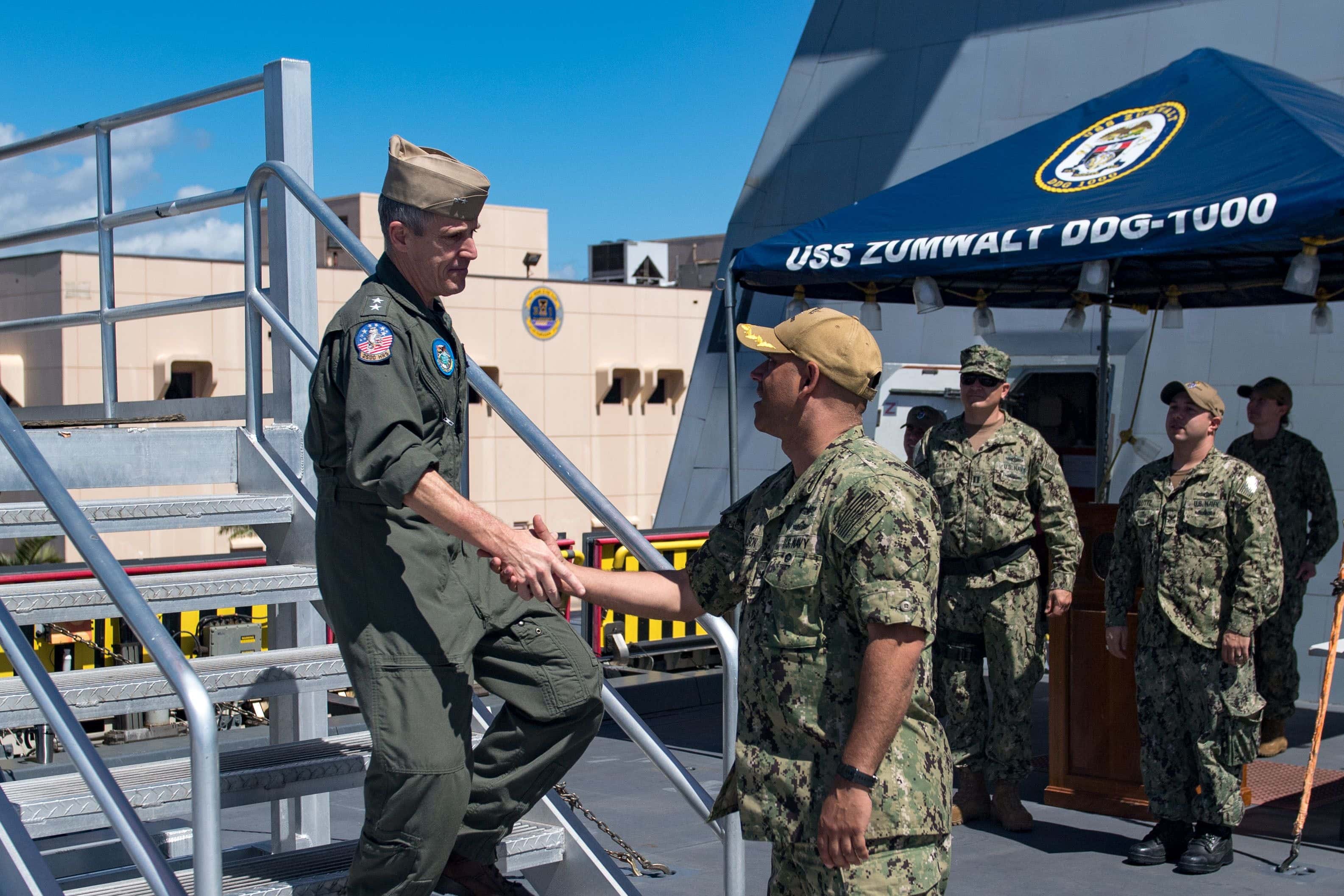 190406-N-DA737-0052 PEARL HARBOR, Hawaii (Apr. 6, 2019) Capt. Andrew Carlson, commanding officer of guided-missile destroyer USS Zumwalt (DDG 1000), shakes hands with Rear Adm.