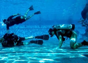 CORONADO, Calif. (Nov. 5, 2019) Mass Communication Specialist 3rd Class Alex Perlman (left), assigned to Commander, Naval Special Warfare Command (NSWC) photographs U.S. Navy SEAL candidates participating in Basic Underwater Demolition/SEAL (BUD/S) training.