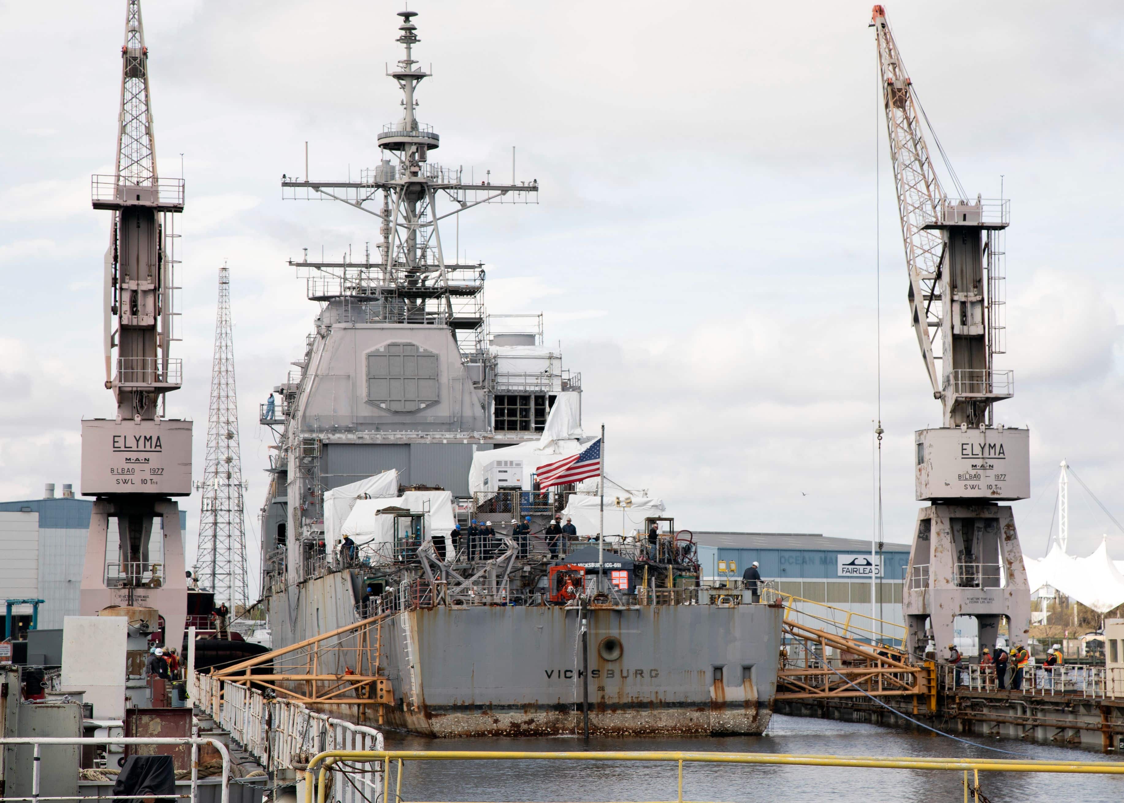 200324-N-KP445-1011 NORFOLK, VA (March 24, 2020) USS Vicksburg (CG 69) is maneuvered into a dry dock during a docking evolution at BAE Systems Shipyard in Norfolk, Virginia. Vicksburg is in the final phase of a Special Selected Restricted Availability (SSRA) as part of the Navy’s Guided Missile Cruiser/Landing Ship