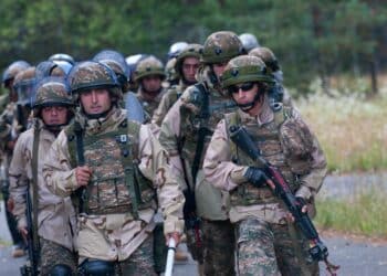 A company of Armenian crowd riot control and patrol platoons comes back from a patrol in the mock village of Lesak at Joint Multinational Readiness Center, Hohenfels, Germany. The exercise prepares the soldiers to work with their international counterparts in a joint effort to respond and react to emergency situations. The soldiers are part of a multinational group that is drawn from nearly 30 NATO countries to help with the peacekeeping mission in Kosovo.