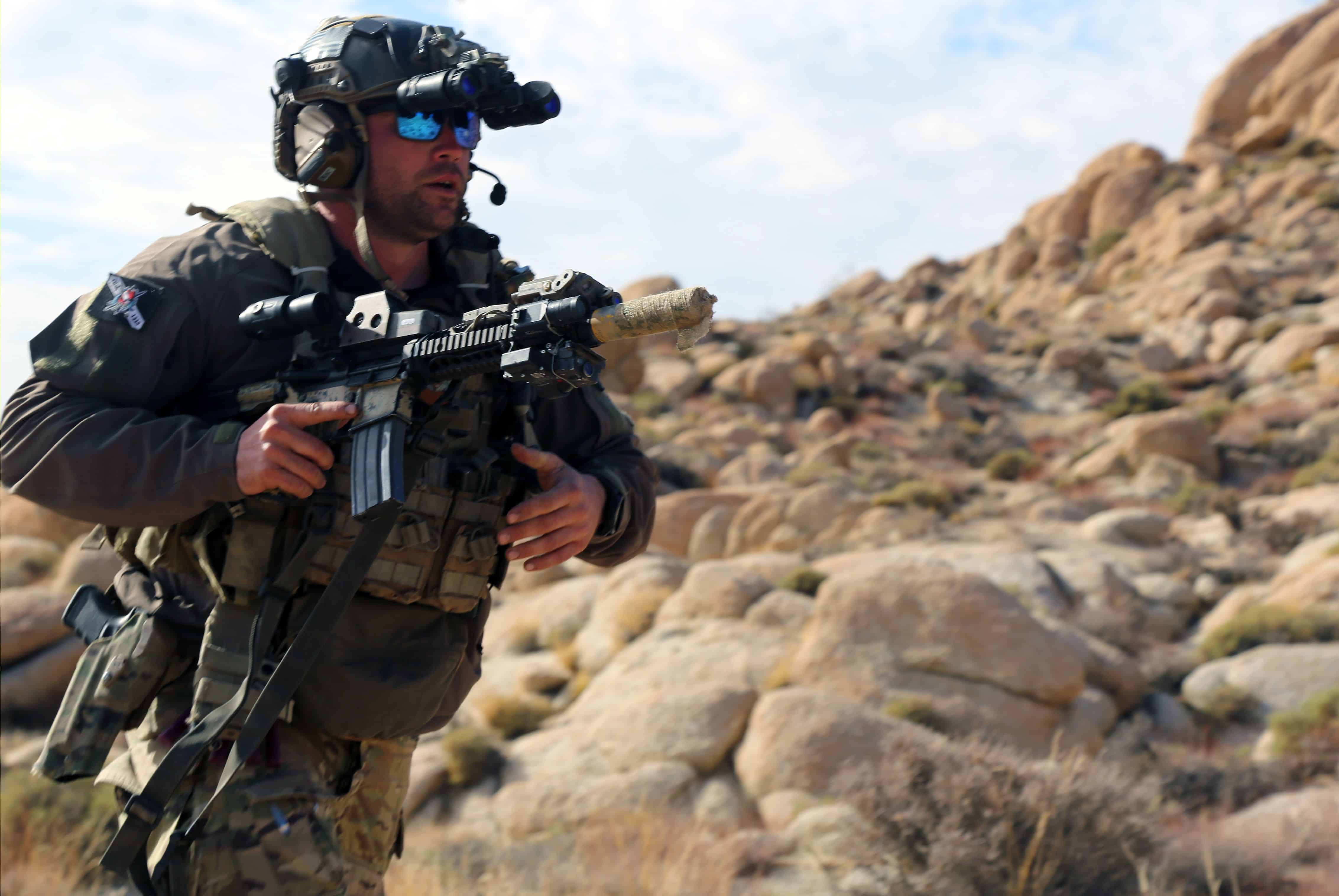 FORT IRWIN, Calif.- A U.S. Army Green Beret with 1st Special Forces Group (Airborne) maneuvers to counter an enemy attack during a notional ambush at the National Training Center, Fort Irwin, Calif., on March 17, 2021. The training exercises focused on the Green Berets