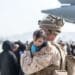 210821-M-GQ845-1048 HAMID KARZAI INTERNATIONAL AIRPORT, Afghanistan (August 21, 2021) A Marine with Special Purpose Marine Air-Ground Task Force-Crisis Response-Central Command (SPMAGTF-CR-CC) calms an infant during an evacuation at Hamid Karzai International Airport, Kabul, Afghanistan, Aug. 21. U.S.