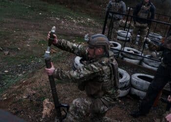 A Green Beret assigned to 10th Special Forces Group (Airborne) loads a 60-mm mortar round in Navenakhevi, Georgia, March 20, 2023. Combined training between U.S. Army Special Forces and Georgian Special Operations Forces increased anti-armor weapon systems and indirect fire interoperability. (U.S. Army photo by Spc. Jordan S. Worthy) (This photo has been altered for security purposes.)