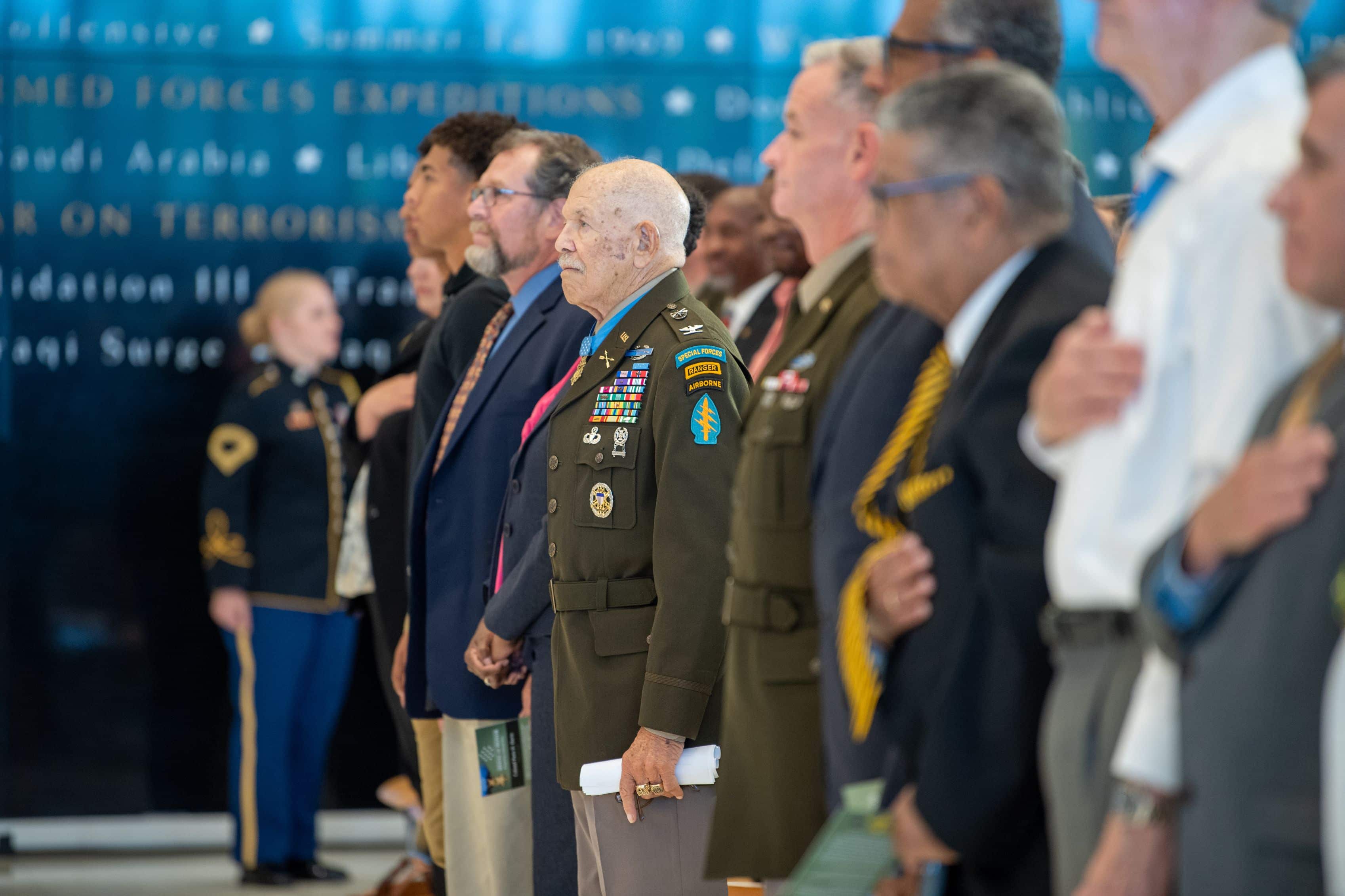 The audience stands as Director of the Army Staff, Lt. Gen. Walter E. Piatt arrives for the engraving unveiling ceremony in honor of Medal of Honor recipient, retired U.S. Army Col. Paris Davis, at the National Museum of the U.S. Army, Fort Belvoir, Va., Aug. 9, 2023.