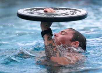 A competitor in the 2023 U.S. Army Special Operations Command (USASOC) Best Dive Team Competition treads water while keeping a 15-pound weight above his head at the U.S. Army John F. Kennedy Special Warfare Center and School's Special Forces Underwater Operations School at NAS Key West, Florida Sept. 26, 2023.