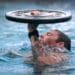A competitor in the 2023 U.S. Army Special Operations Command (USASOC) Best Dive Team Competition treads water while keeping a 15-pound weight above his head at the U.S. Army John F. Kennedy Special Warfare Center and School's Special Forces Underwater Operations School at NAS Key West, Florida Sept. 26, 2023.
