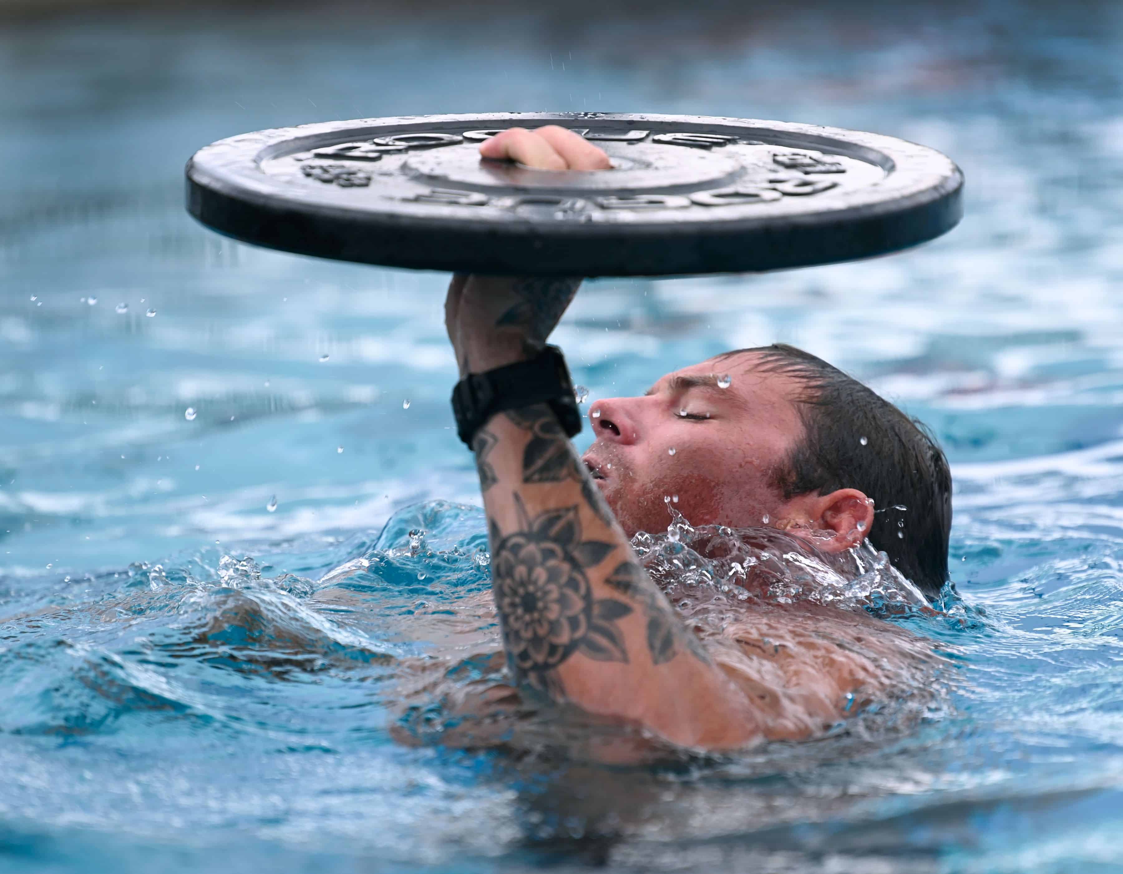 A competitor in the 2023 U.S. Army Special Operations Command (USASOC) Best Dive Team Competition treads water while keeping a 15-pound weight above his head at the U.S. Army John F. Kennedy Special Warfare Center and School's Special Forces Underwater Operations School at NAS Key West, Florida Sept. 26, 2023.