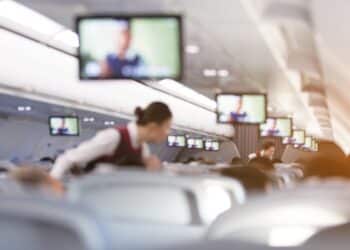Blurred abstract background of Flight attendant serving passengers on the plane.