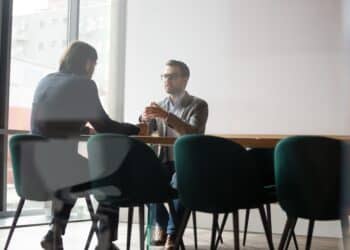 Negotiations process behind wall door concept, human resources manager interviewing candidate of company position, two businessmen business meeting, insurance broker makes offer deal with firm client