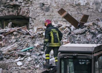 Amatrice, Rieti Italia - 08 25 2016: a fireman search and rescue among the ruins during the earthquake magnitude 6 in central Italy. Victims Turkey Morocco Syria Ukraine Pakistan Marrakesh emergency