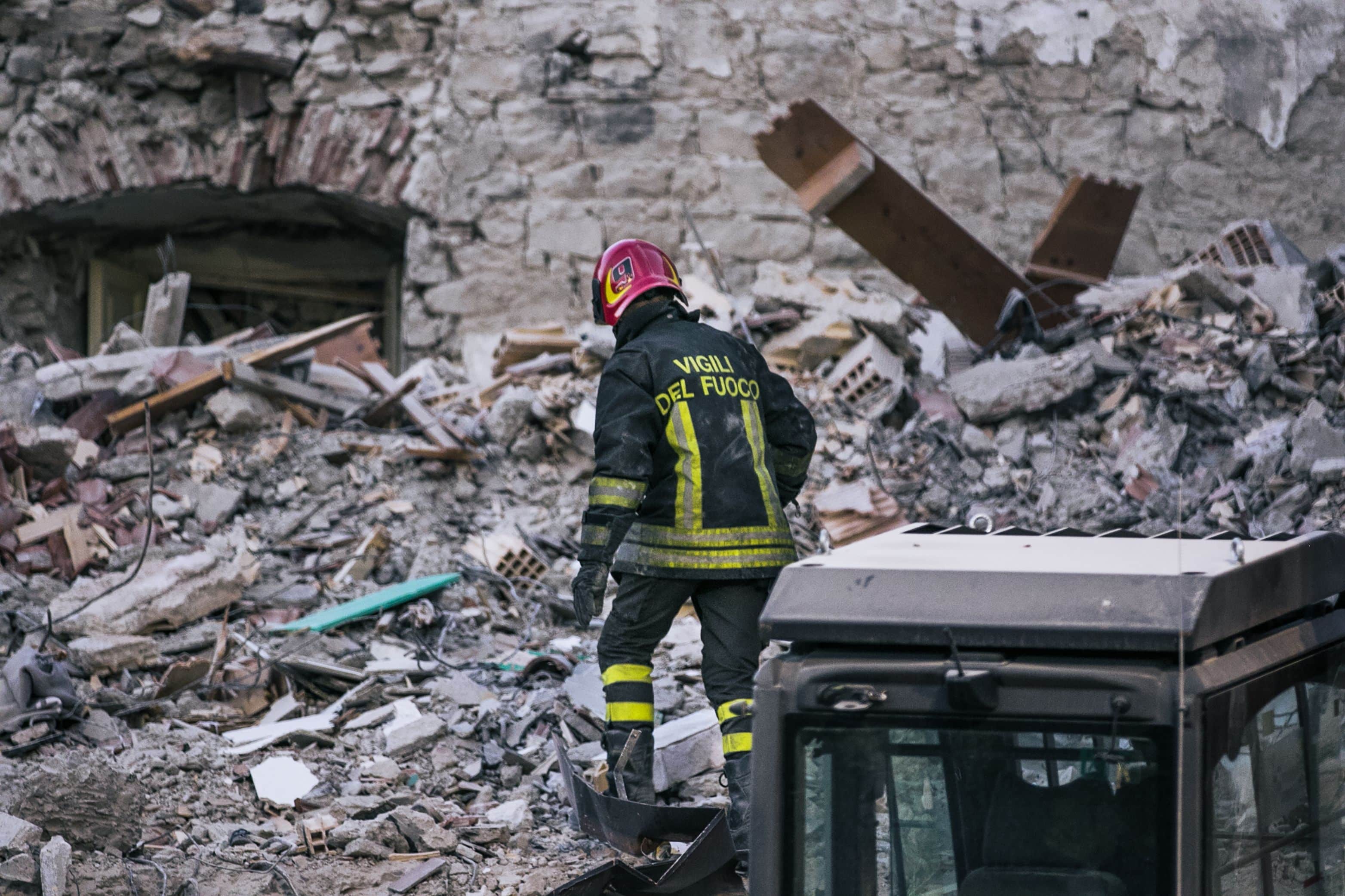 Amatrice, Rieti Italia - 08 25 2016: a fireman search and rescue among the ruins during the earthquake magnitude 6 in central Italy. Victims Turkey Morocco Syria Ukraine Pakistan Marrakesh emergency