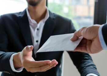 leader manager giving money bonus in paper envelope to business man worker employee for increasing of salary or promotion new position in meeting room office, unemployment, business company concept