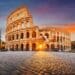 Rome, Italy at the Colosseum Amphitheater with the sunrise through the entranceway.