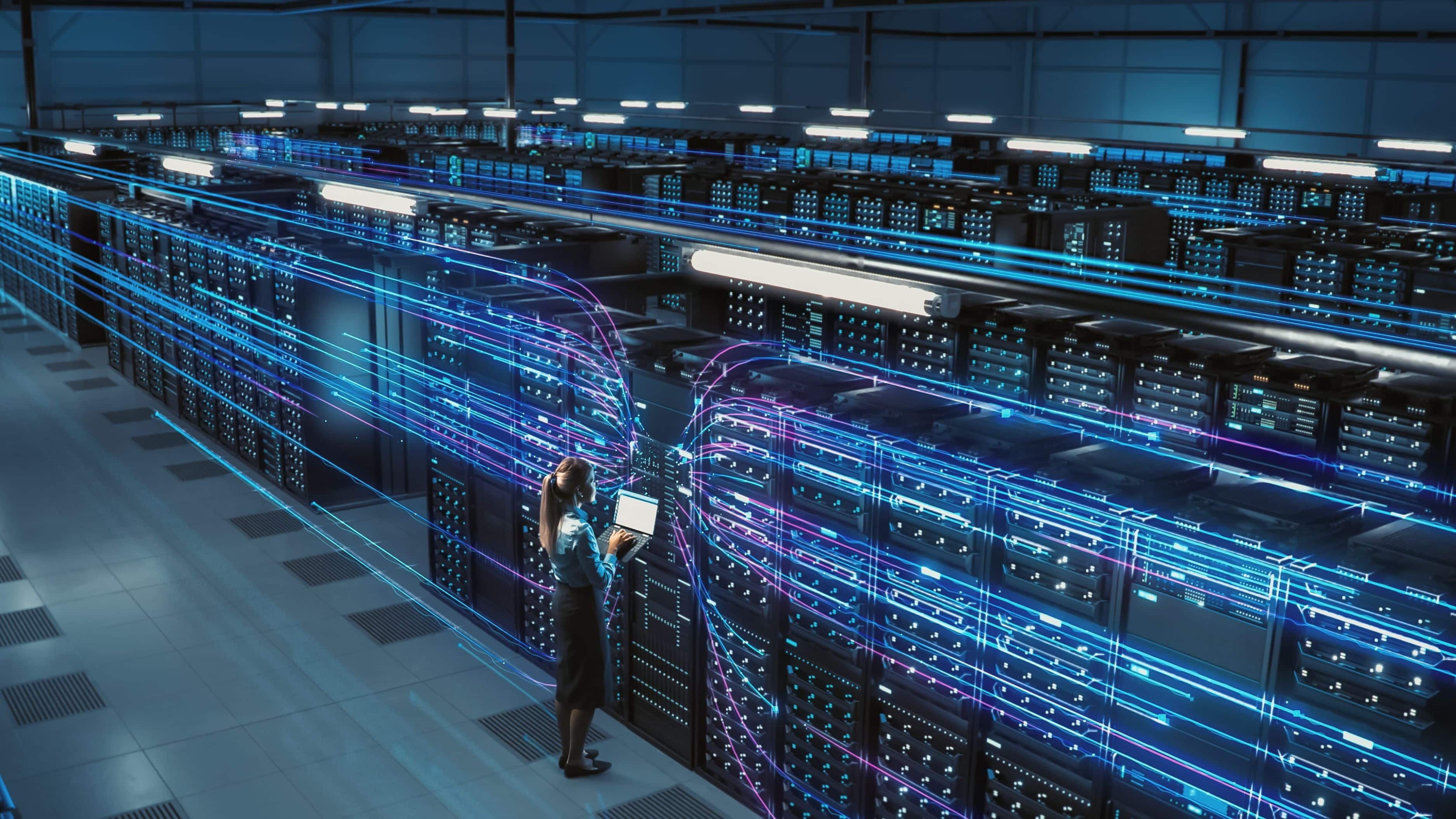3D Graphics Concept: Big Data Center Female Chief Technology Officer Using Laptop Standing In Warehouse, Activates Servers, Information Digitalization Starts. SAAS, Cloud Computing, Web Service