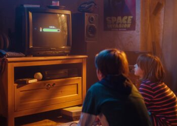 Nostalgic Childhood Concept: Young Boy and Girl Playing Old-School Arcade Video Game on a Retro TV Set at Home in a Room with Period-Correct Interior. Kids Waiting For Level to Load.