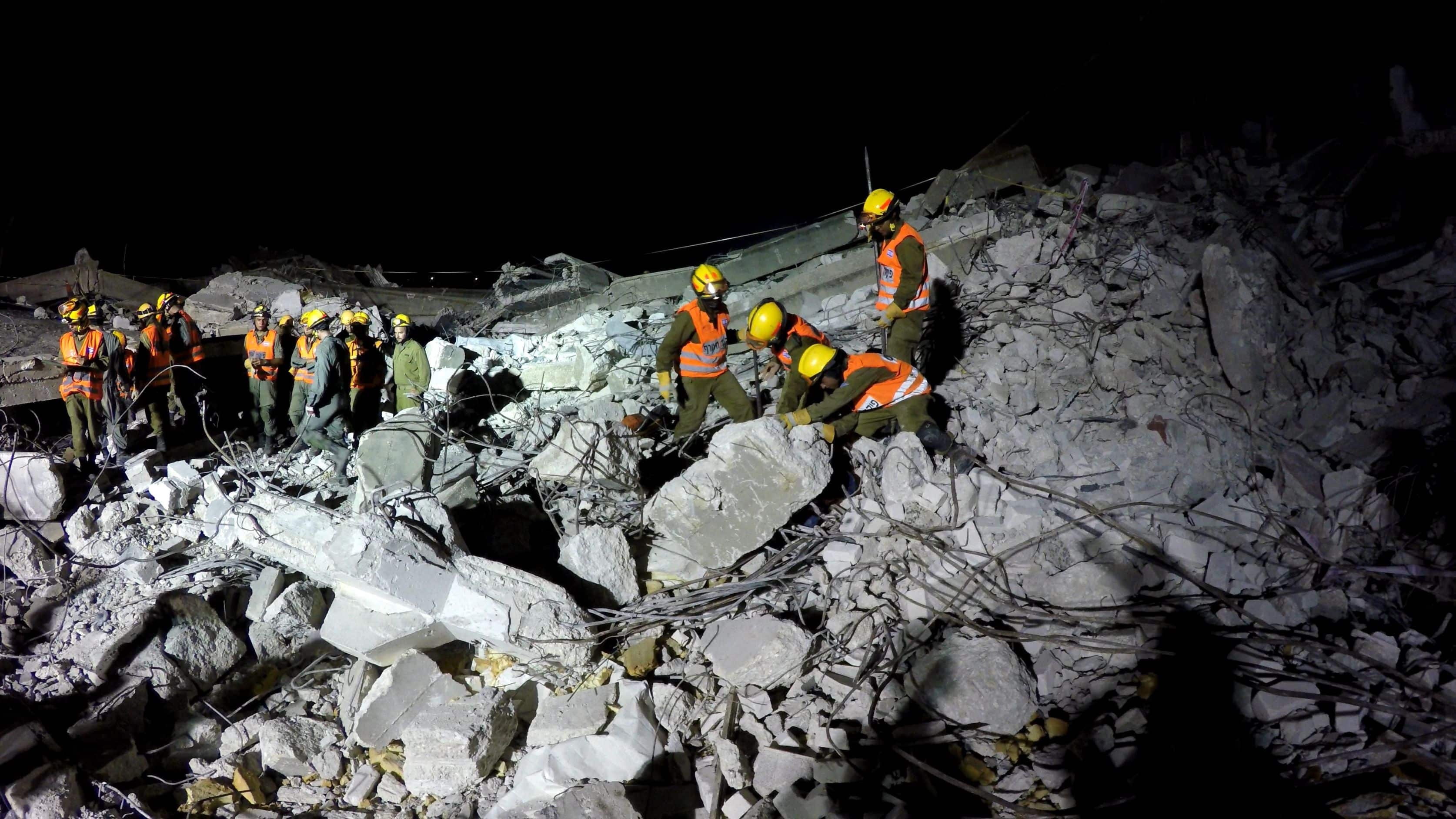 HOLON, ISRAEL JULY 27th, 2015: Homeland Security Soldiers search for earthquake rocket attack tsunami injured people digging through the rubble during night drill