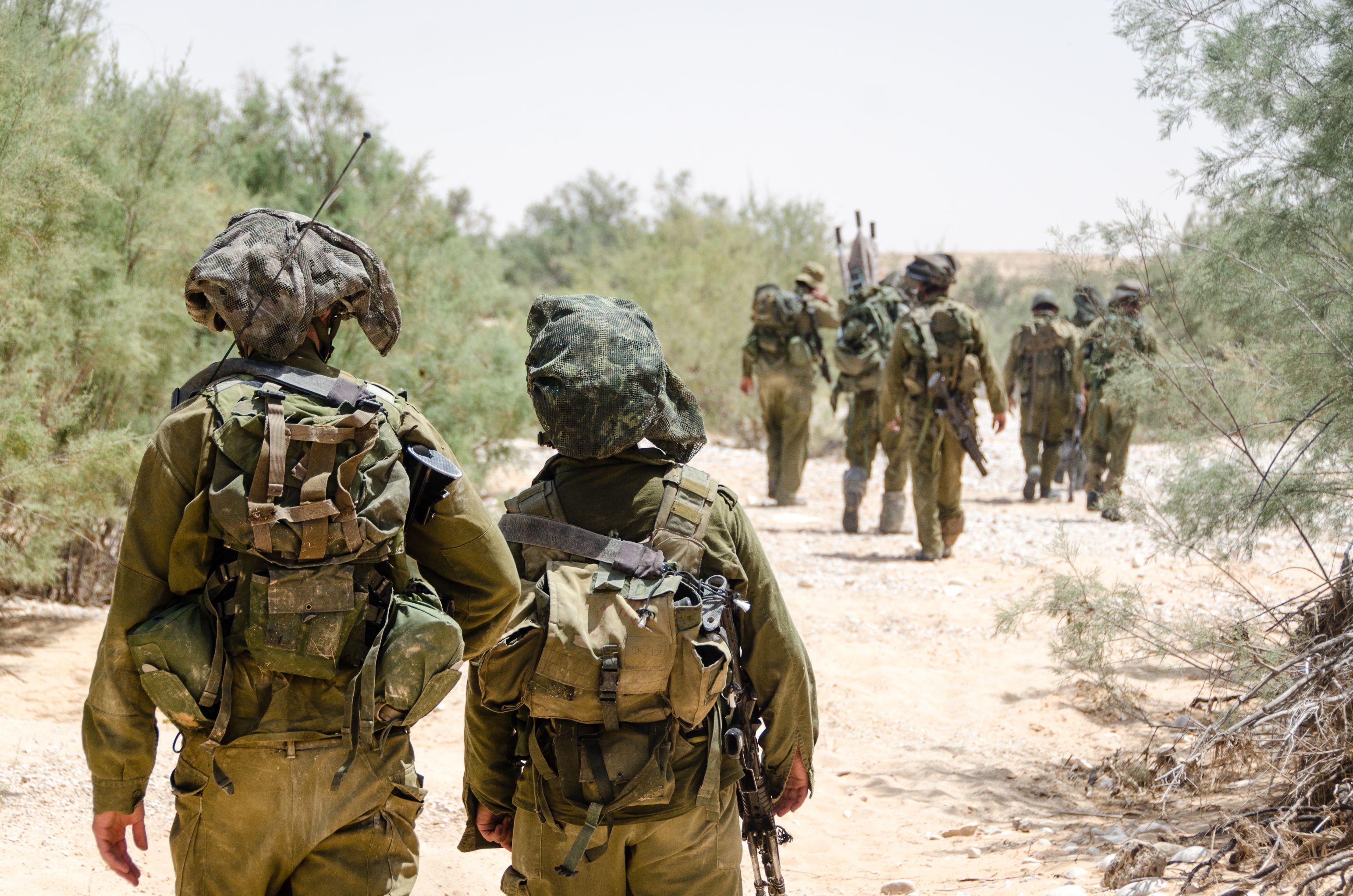 Israeli combat soldiers of an elite counter-terror unit return back to base after a raid in South of Lebanon during the Second Lebanon military campaign / war. Two soldiers in the foreground.