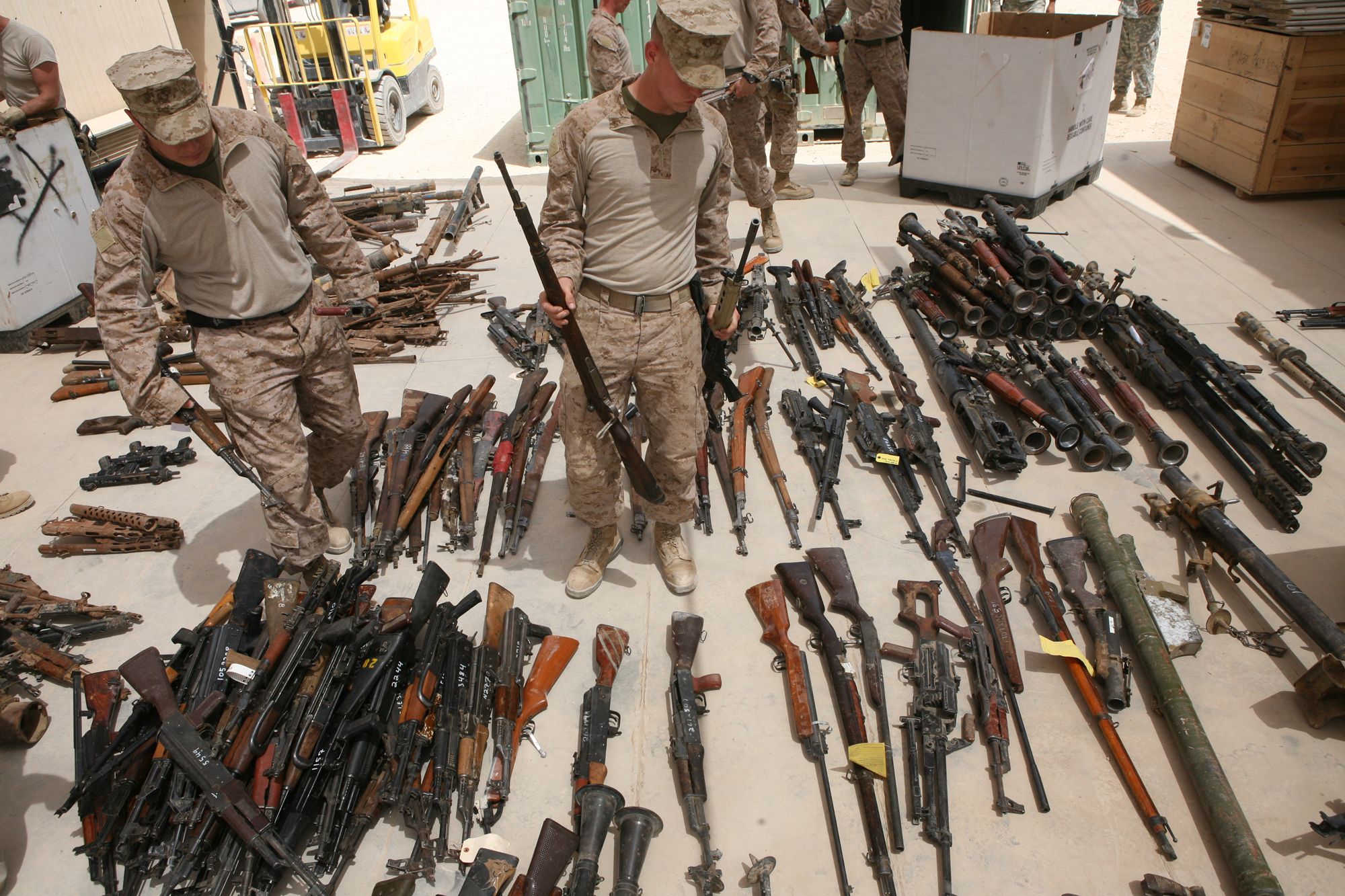 Marines with Engineer Ordnance Maintenance Platoon, Maintenance Company, 2nd Supply Battalion Reinforced, 2nd Marine Logistics Group (Forward), sort captured enemy weapons at the Taji National Maintenance Depot aboard Camp Taji, Iraq, July 28. The depot is responsible for destroying unserviceable weapons and turning over serviceable weapons to the Iraqi government to support the Iraqi army.