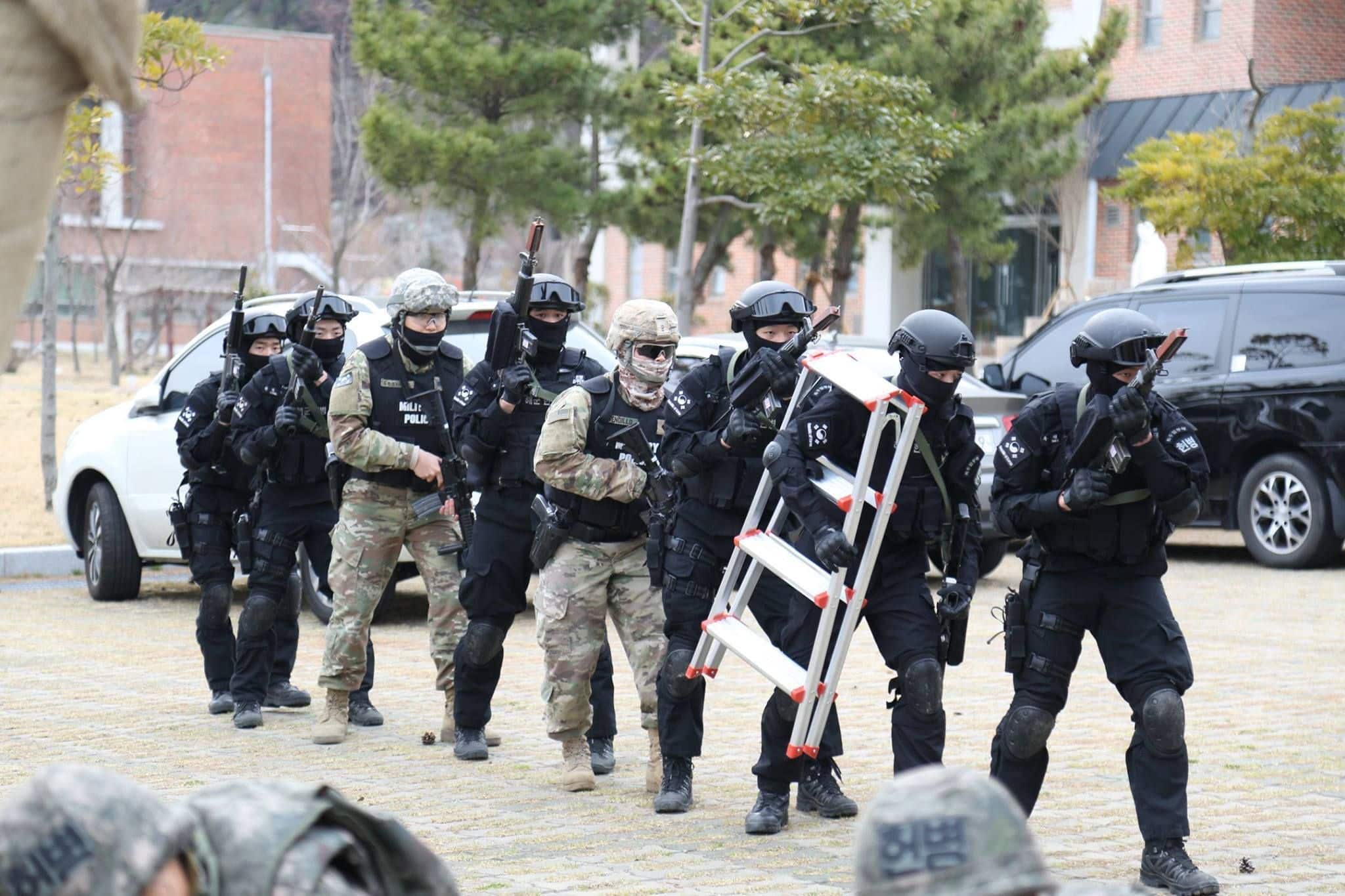 Soldiers from 188th Military Police Company "Original Warfighters" with Republic of Korea Navy Special Duty Team members prepare to engage a notional active shooter and hostage situation, March 16, 2017, at Busan Naval Base. The training enforced and enhanced joint service interoperability. (Photo by Sgt. Uriah Walker, 19th ESC Public Affairs)