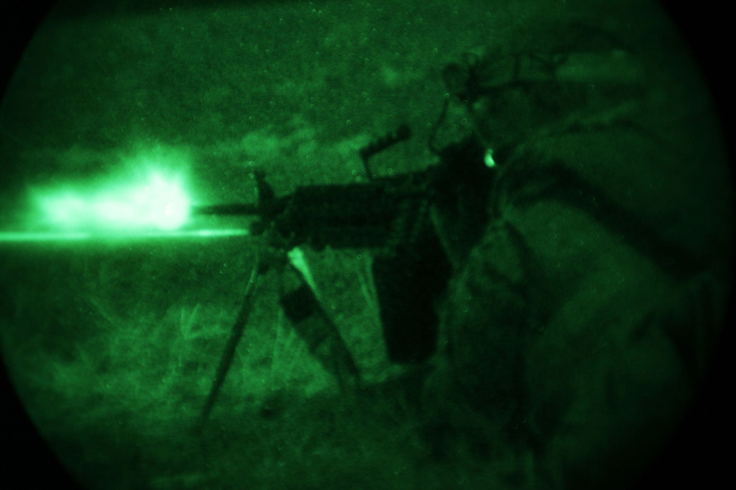 A Marine with Fox Company from the Battalion Landing Team, 2nd Battalion, 2nd Marine Regiment, 22nd Marine Expeditionary Unit, fires an M249 squad automatic weapon during a night assault at the infantry platoon battle course aboard Fort Pickett, Va., Dec. 13, 2010.