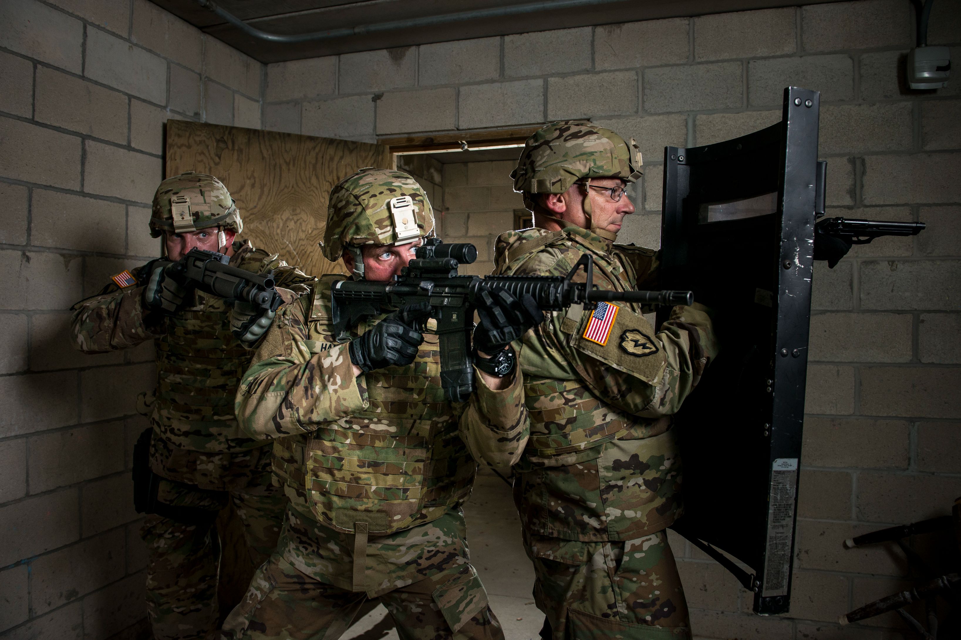 U.S. Army Reserve military police Soldiers from the 430th Military Police Detachment (Law Enforcement), located in Red Bank, New Jersey, run through a Military Operations on Urban Terrain (MOUT) drill during a photo shoot for Army Reserve recruiting at Joint Base McGuire-Dix-Lakehurst, New Jersey, July 25, 2017.