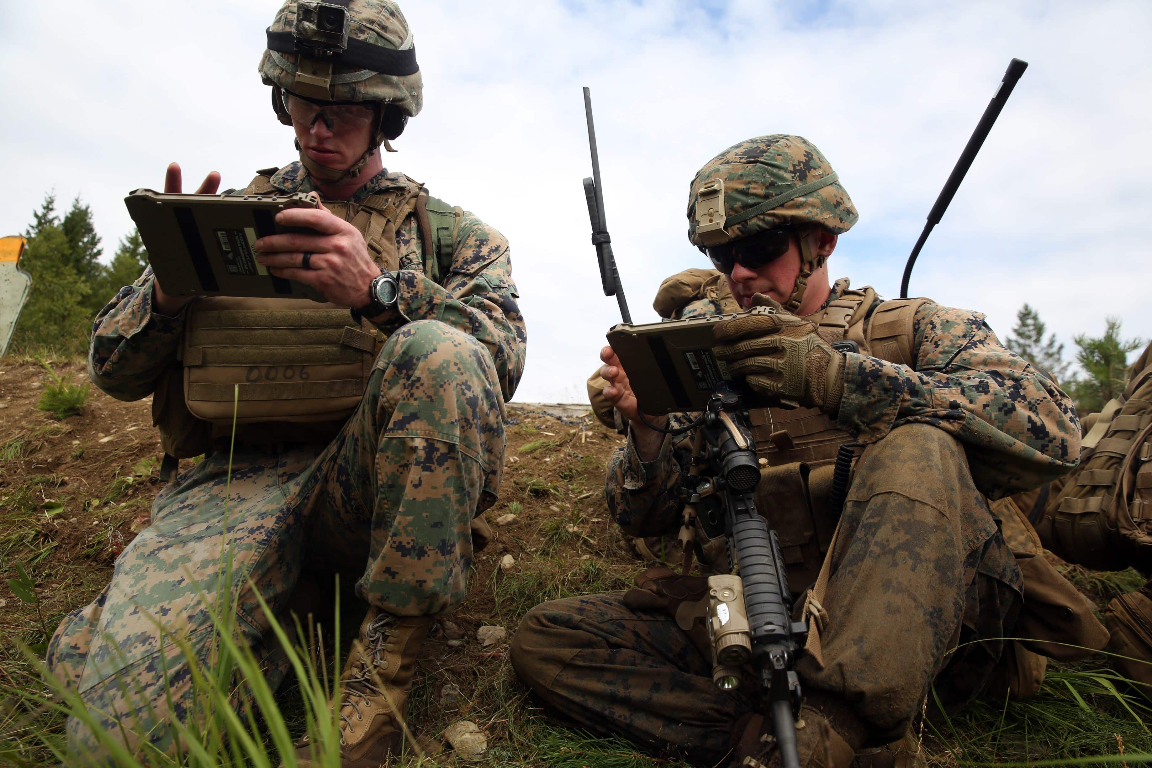 U.S. Marines with Marine Rotational Force-Europe 18.1 relay information through the Marine Air Ground Task Force (MAGTF) Common Handheld during a platoon-supported attack range at Giskas, Norway, Aug. 7, 2018.