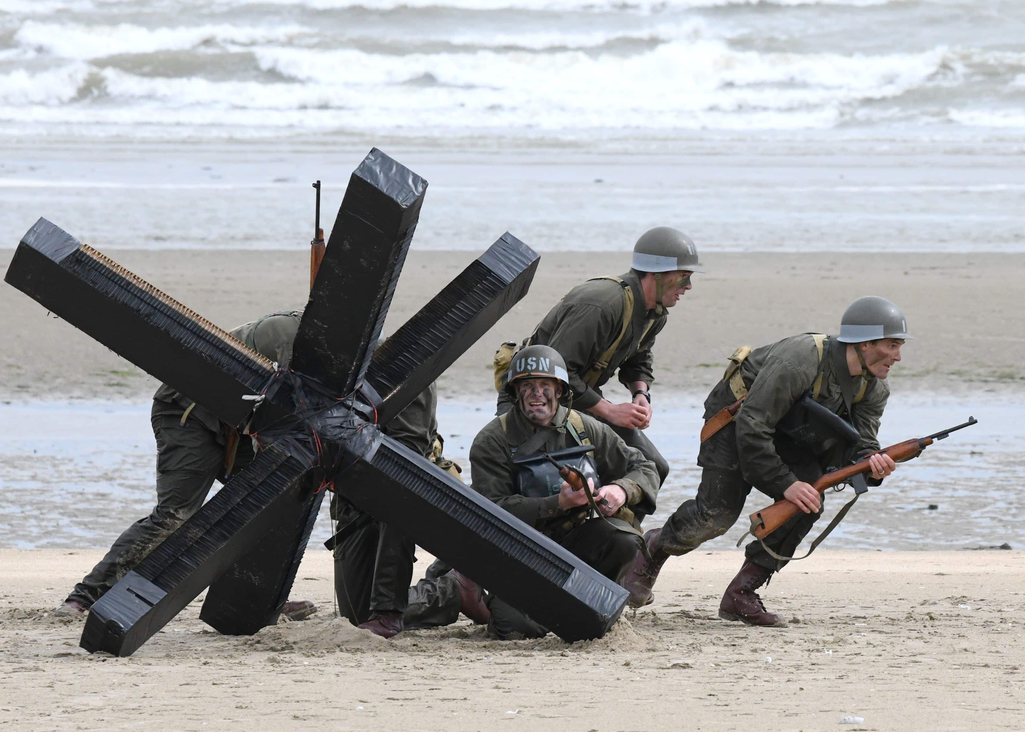 U.S. Navy SEALS assigned to Special Warfare Unit 2 re-enact the D-Day mission Navy Combat Demolition Unit Sailors conducted in the cover of darkness to clear the beaches for the main invading force on Utah Beach, June 7, 2019.