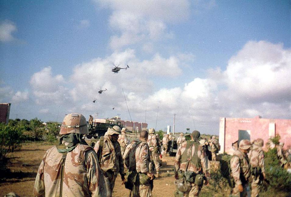 Army soldiers of Company B, 2nd Battalion, 14th Infantry Regiment, watch helicopter activity over Mogadishu, Oct. 3, 1993. Later the same day and throughout the night, the battalion's A and C Companies were part of a rescue convoy assembled for nearly 100 Rangers who had become trapped in the city after two Black Hawks were shot down. Army photo
