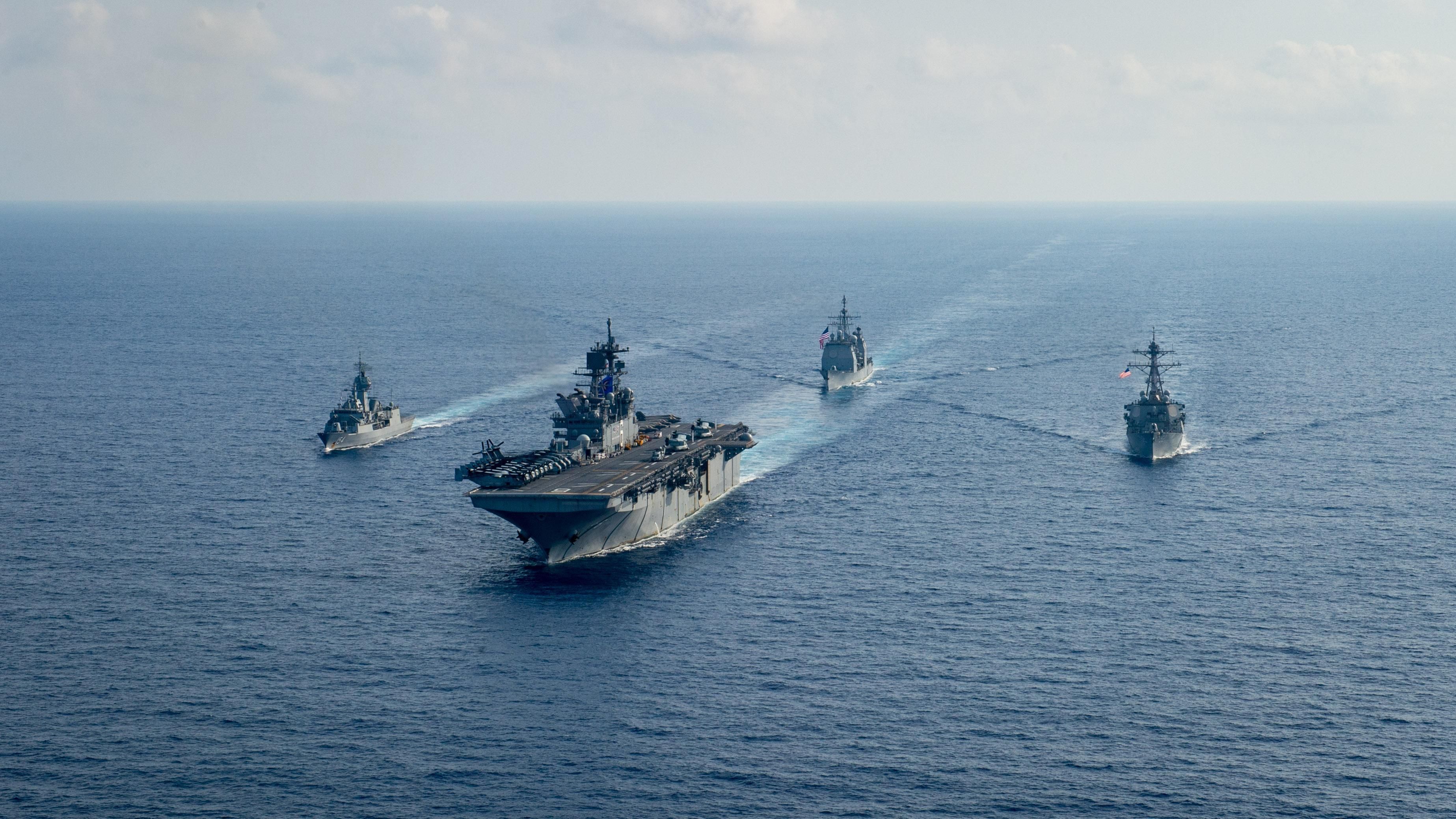 Royal Australian Navy guided-missile frigate HMAS Parramatta (FFH 154), left, sails with U.S. Navy Amphibious assault ship USS America (LHA 6), Ticonderoga-class guided-missile cruiser USS Bunker Hill (CG 52) and Arleigh-Burke class guided missile destroyer USS Barry (DDG 52). Bunker Hill is deployed to the U.S. 7th Fleet area of operations and is operating with the America Expeditionary Strike Group in support of security and stability in the Indo-Pacific region.