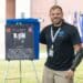 Staff Sgt. Travis Mills stands in front of his personalized plaque after being inducted into the All American Hall of Fame Class of 2020 during a ceremony at the Hall of Heroes on Fort Bragg, N.C., July 9, 2020. A total of 12 82nd Airborne Division veterans were inducted this year for their commitment to the All American Division's values, contributions to the Division's legacy and valor in combat.
