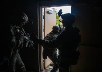 U.S. Marines with 2d Battalion, 6th Marine Regiment, 2d Marine Division exit a building during a Military Operations in Urban Terrain (MOUT) assault raid on Camp Lejeune, N.C., Jan. 12, 2021.