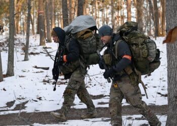 Special Forces candidates assigned to the U.S. Army John F. Kennedy Special Warfare Center and School hike through a wooded area during the final phase of field training known as Robin Sage in central North Carolina, January 23, 2022. Robin Sage is the culmination exercise for Soldiers in the Special Forces Qualification Course and has been the litmus test for Soldiers striving to earn the Green Beret for more than 50 years. (U.S. Army photo by K. Kassens)