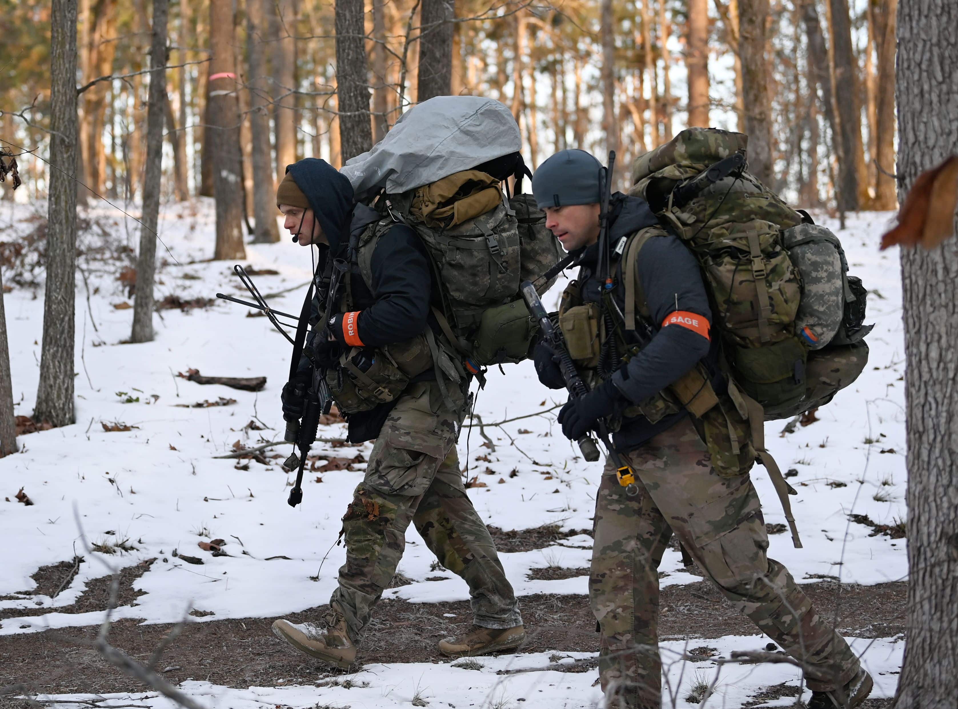 Special Forces candidates assigned to the U.S. Army John F. Kennedy Special Warfare Center and School hike through a wooded area during the final phase of field training known as Robin Sage in central North Carolina, January 23, 2022. Robin Sage is the culmination exercise for Soldiers in the Special Forces Qualification Course and has been the litmus test for Soldiers striving to earn the Green Beret for more than 50 years. (U.S. Army photo by K. Kassens)
