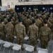 Soldiers assigned to the U.S. Army John F. Kennedy Special Warfare Center and School stand in formation after donning their green berets for the first time during a Regimental First Formation at Fort Bragg, North Carolina February 17, 2022