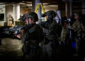 Operators secure the room following a firefight during a training exercise in Battle Creek, Michigan, August 10, 2022. The operation integrated guardsmen from the Birmingham, Alabama-headquartered 20th Special Forces Group (Airborne) with local, state, and federal law enforcement partners to infiltrate a complex building, neutralize enemies, rescue hostages and recover hazardous materials. The event was part of Northern Strike 22