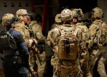 Operators plan their route through additional levels of an enemy compound during a training exercise in Battle Creek, Michigan, August 10, 2022.