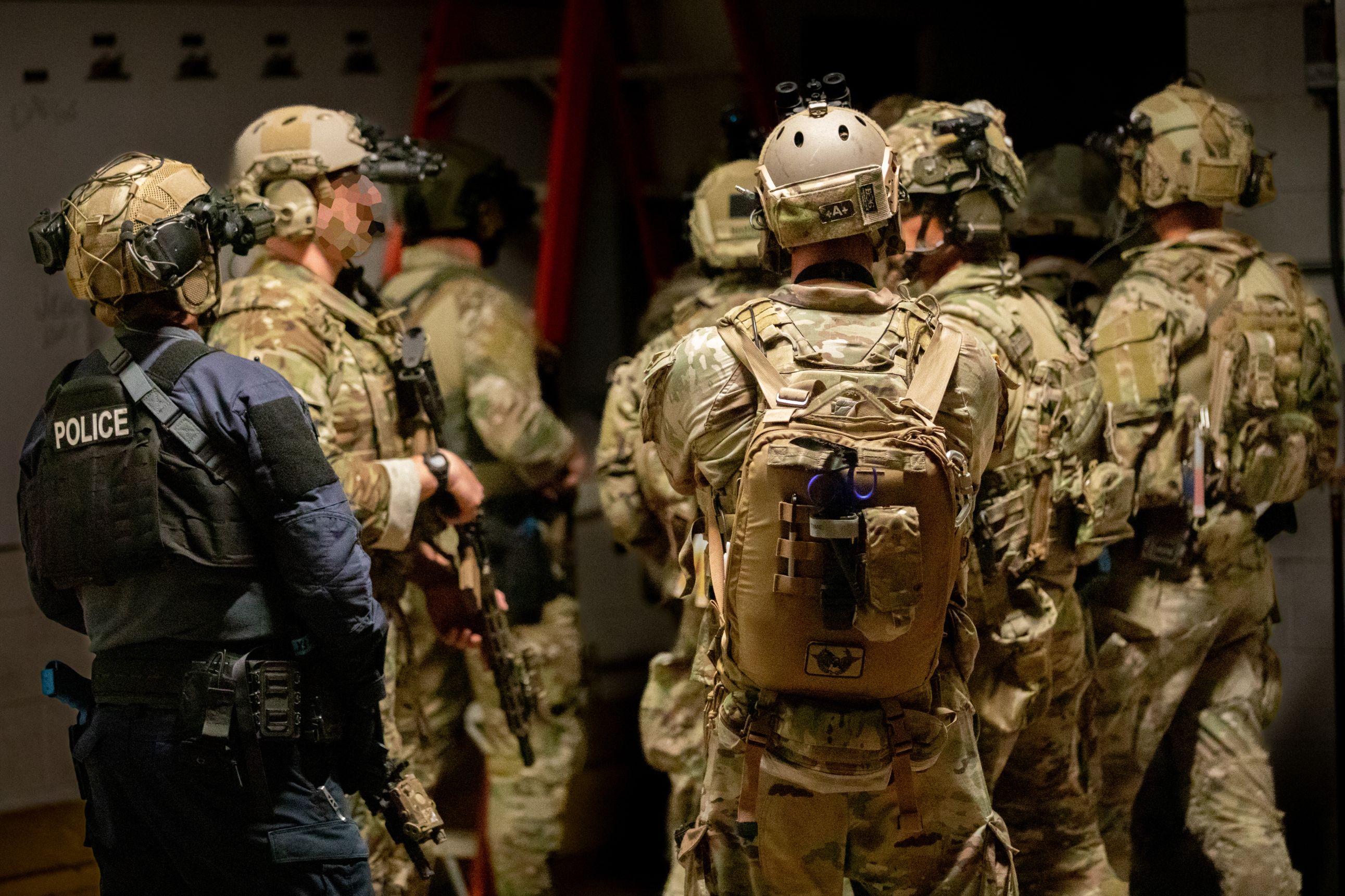 Operators plan their route through additional levels of an enemy compound during a training exercise in Battle Creek, Michigan, August 10, 2022.