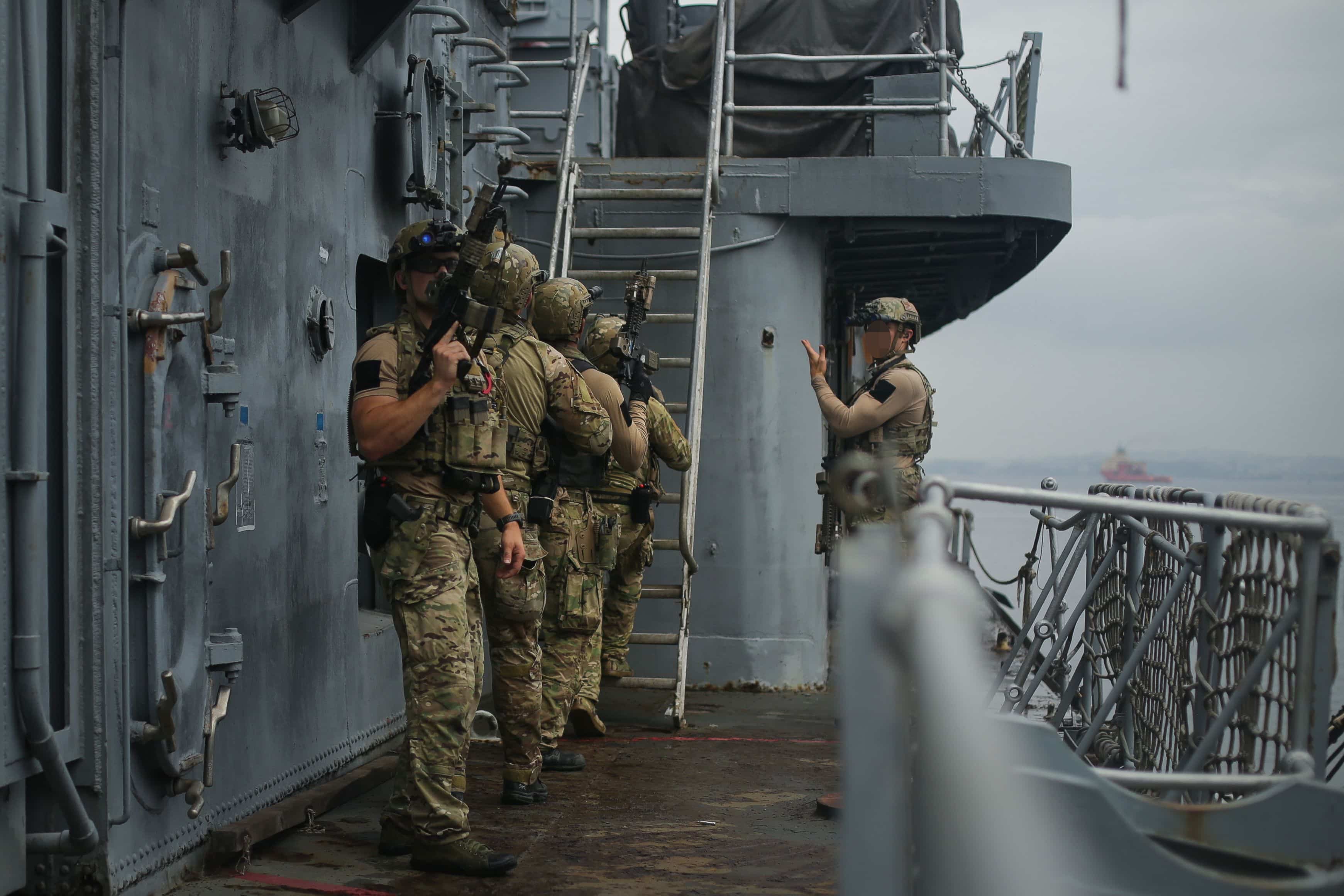 U.S. Sailors assigned to a Navy SEAL Team, make their way toward a command deck during Visit, Board, Search, and Seizure (VBSS) training with partner nations during exercise UNITAS LXIII in Rio de Janeiro, Sept. 12, 2022.
