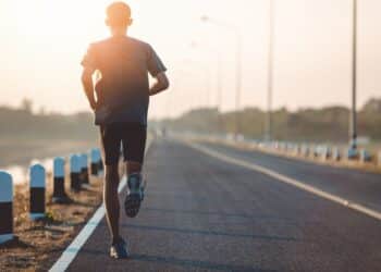 Athlete runner feet running on road