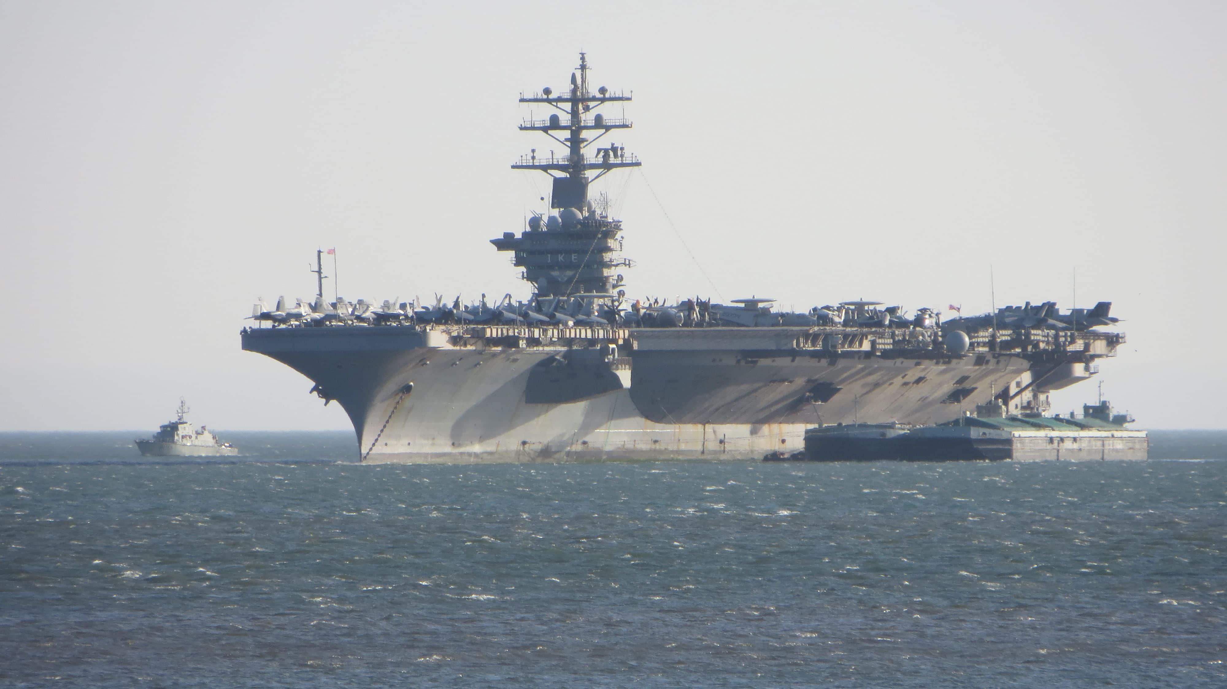 Lisbon / Portugal - June 22, 2013: USS Dwight D. Eisenhower (CVN-69) (known informally as "Ike") anchored on the entrance of the Tagus river estuary, Lisbon, Portugal.