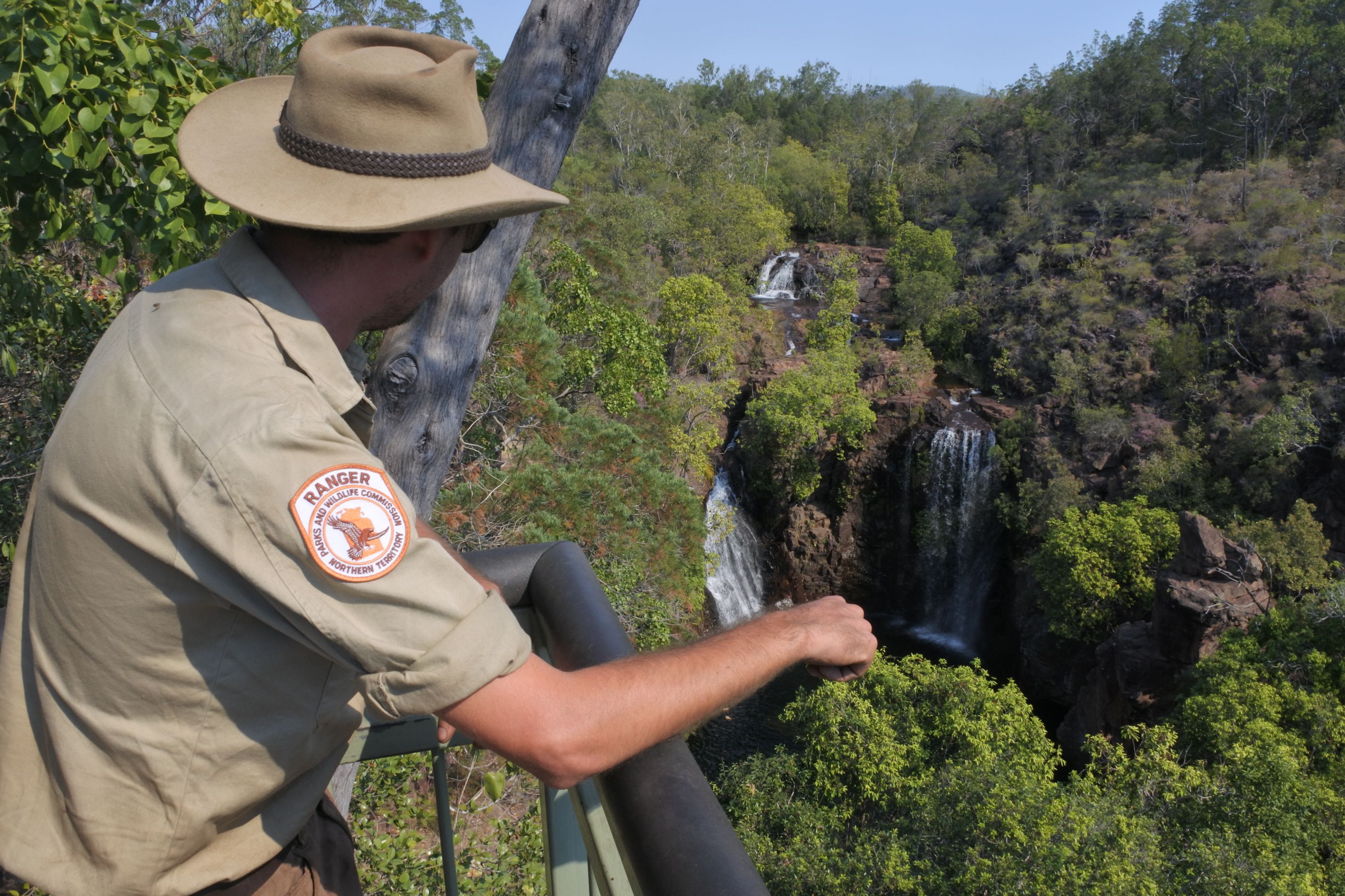 DARWIN, NT - JULY 11 2019:Park Ranger looking at Wangi Falls in Litchfield National Park.Australian park rangers working to protect Australia national parks resources and to protect park visitors.