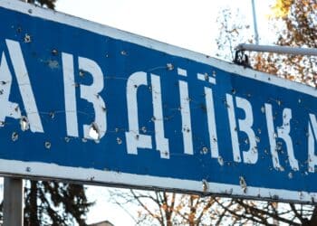 Road sign with the inscription in Ukrainian - Avdiivka, Donetsk region, broken by bullets during the Ukrainian war in Donbass, Ukraine. Ukraine Russia war, destruction, zone ATO, OOS