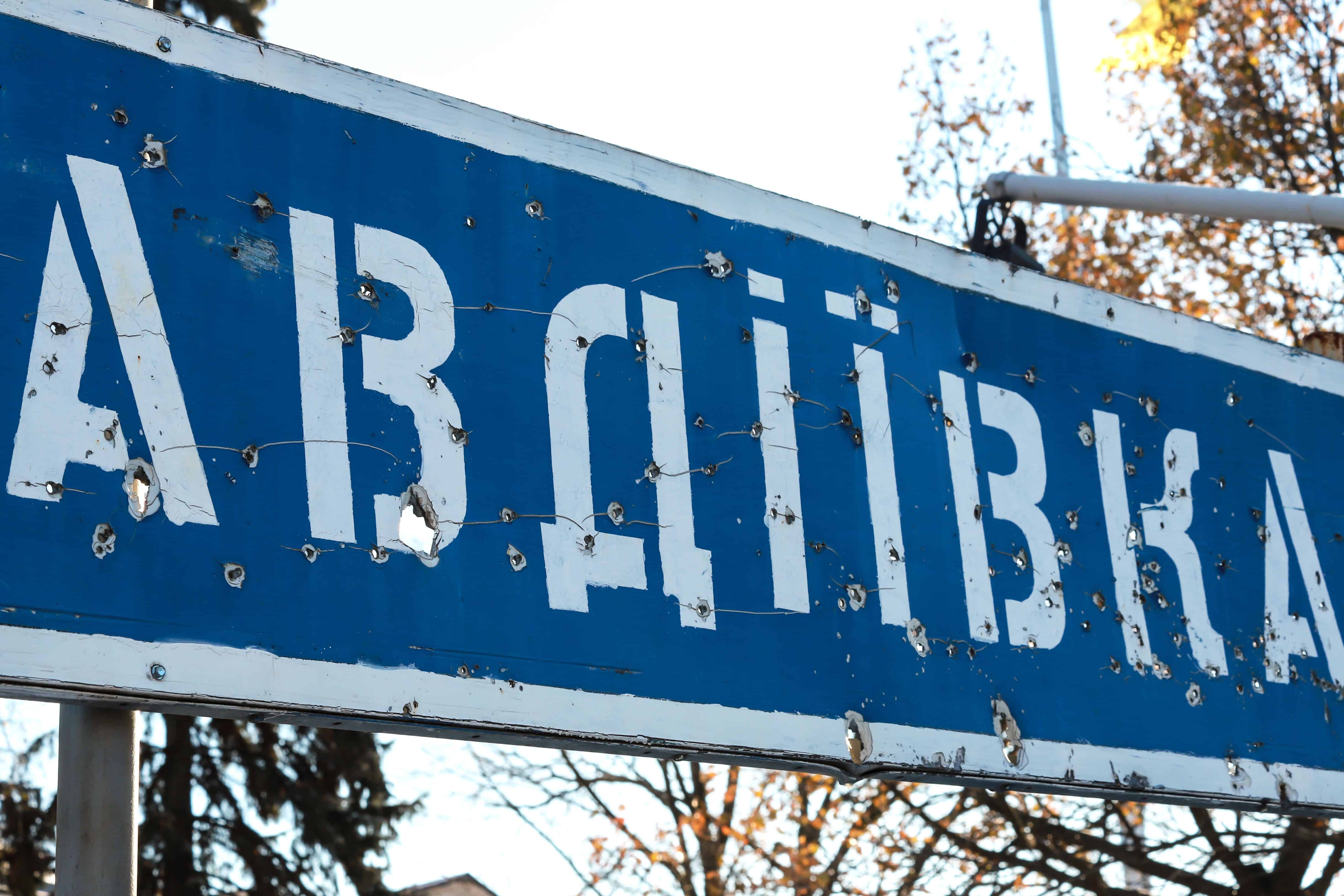 Road sign with the inscription in Ukrainian - Avdiivka, Donetsk region, broken by bullets during the Ukrainian war in Donbass, Ukraine. Ukraine Russia war, destruction, zone ATO, OOS