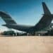 Loading military cargo at the airport. Military cargo plane. Delivery of weapons. 3d illustration