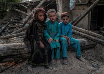 Poor and needy Afghan children sitting on the ground after an earthquake - Paktika, Afghanistan August 4, 2022