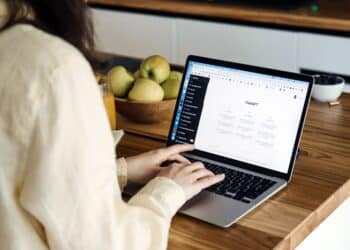 ChatGPT for content creators, ChatGPT help generate ideas and create content. Screen with ChatGPT AI or artificial intelligence chat and typing female hands. Warsaw, Poland - May 02, 2023